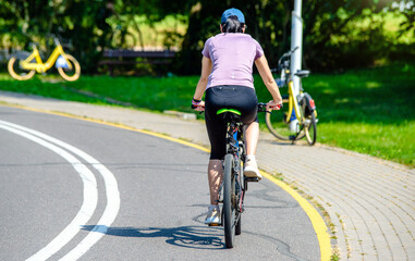 Cyclist ride on the bike path in the city Park
