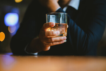 Whiskey drinks at the bar celebrating a special event in a luxury bar. Close-up shows a cheerful atmosphere as glasses clink together, reflecting a lively and joyful gathering.