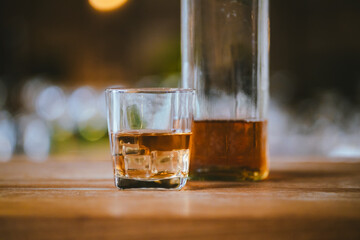Whiskey drinks at the bar celebrating a special event in a luxury bar. Close-up shows a cheerful atmosphere as glasses clink together, reflecting a lively and joyful gathering.