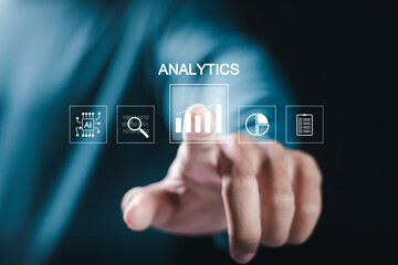 Businessman with business analytics and data management system on virtual screen. Business data analytics and process automation management with icon of KPI financial charts and graph.