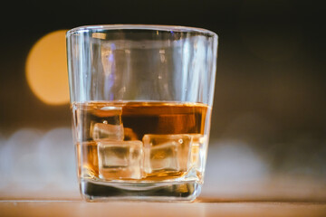 Whiskey drinks at the bar celebrating a special event in a luxury bar. Close-up shows a cheerful atmosphere as glasses clink together, reflecting a lively and joyful gathering.