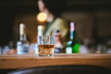 Whiskey drinks at the bar celebrating a special event in a luxury bar. Close-up shows a cheerful atmosphere as glasses clink together, reflecting a lively and joyful gathering.