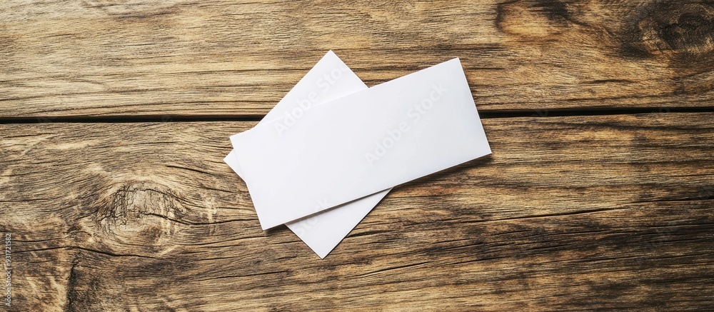 Poster image of empty business cards on a wooden table background id template copyspace for text top view