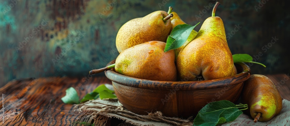 Leinwandbilder ripe pears in a bowl on a wooden table. with copy space image. place for adding text or design