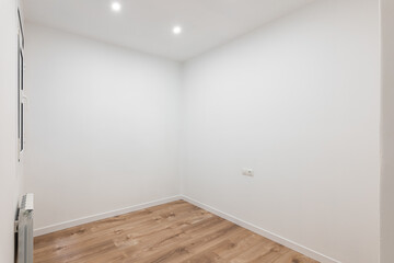 White room with wooden floor, recessed lighting, contemporary and peaceful design