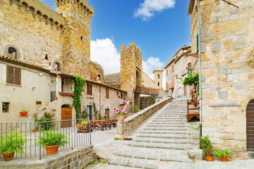 Bolsena, Italy. View from Piazza della Rocca of the Castle of Bolsena called Rocca Monaldeschi. plants and flowers decorating the streets. Beautiful Italian medieval village. 2024-06-21.