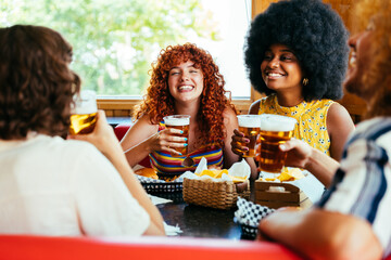 Multiethnic group of friends having meal at 80s vintage diner restaurant - Multiracial young people bonding and having fun, eating in an american fast food burger house