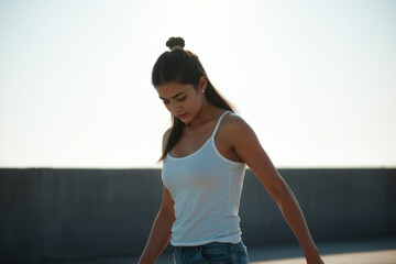 Fototapeta premium Portrait of a young woman in a white tank top