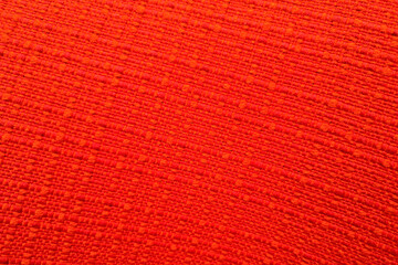 Texture of bright red fabric, close-up. Background