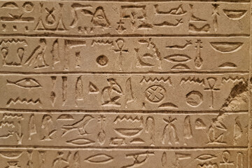 Ancient Egyptian stone carving with hieroglyphs, featuring intricate symbols and sacred inscriptions.