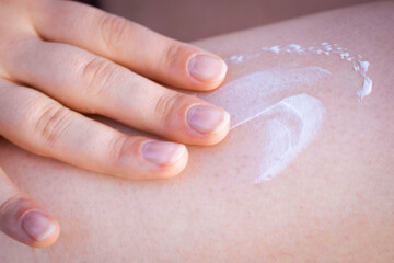Girl applying cream. SPF cream. Cream texture. Close-up. Moisturizing cream. Beach time. Rest. Relaxation