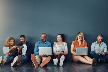 Studio, floor and team of business people with laptop, smile and online connectivity with mockup space. Tech agency, creative and group of friends relax with digital networking on grey background
