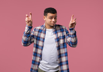 Young Teenage Guy with hands two fingers air quotes gesture on pink, sarcasm