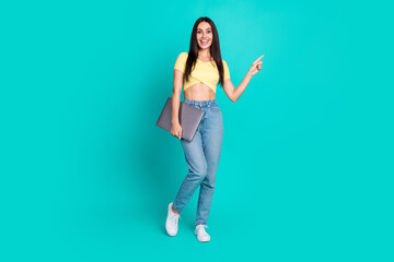 Naklejka premium Full body portrait of nice young woman direct finger empty space wear top isolated on turquoise color background