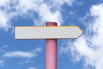 Empty white wooden road sign with a background of a blue sky and white clouds.