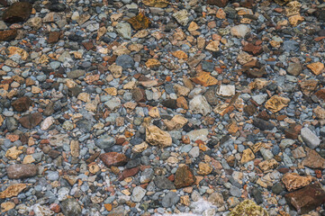 texture of the stones at bottom of the river with clear clear water