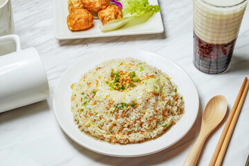 Egg Fried Rice with Dancing Sakura Shrimp, Fried squid balls, Taiwanese red bean ice tea served in dish isolated on marble background side view of taiwan food