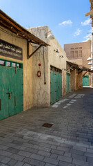 Street of Dubai old city or town or old village Al Seef Khor in Al Fahidi neighborhood, United Arab Emirates. Vertical image