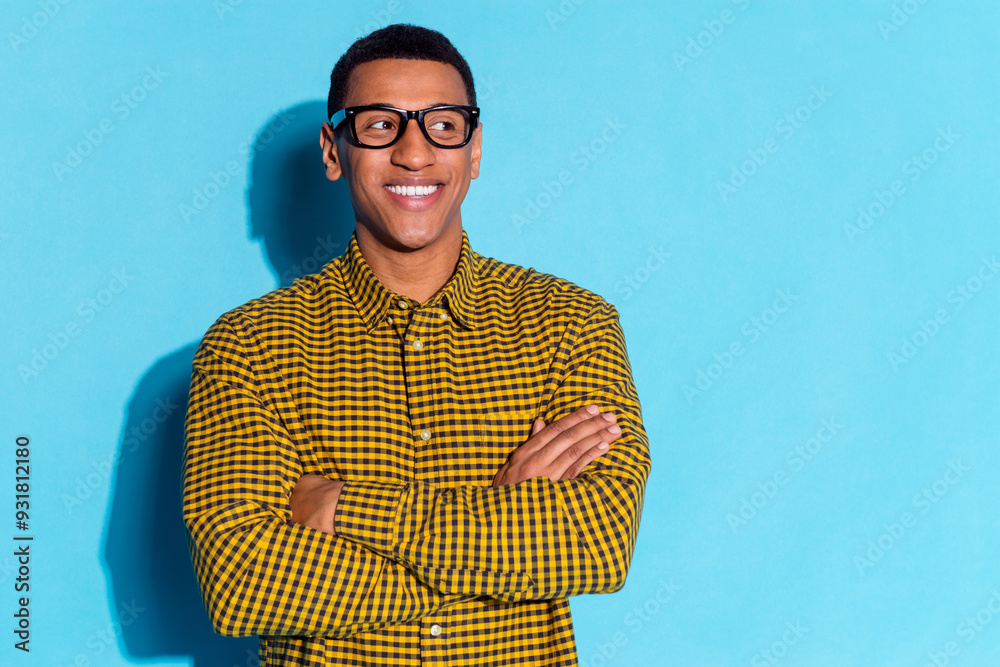 Canvas Prints Photo of handsome young guy crossed hands confident look empty space dressed stylish plaid garment isolated on blue color background