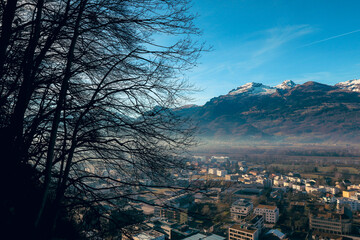 Fototapeta premium Panoramic view of Vaduz showcasing the city nestled between mountains on a clear day