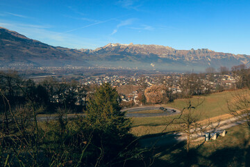 Fototapeta premium Panoramic view of Vaduz with mountains and valley under clear blue sky