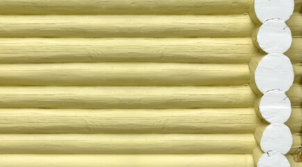 Texture of yellow wooden log wall made of round log house. Wooden Texture background.