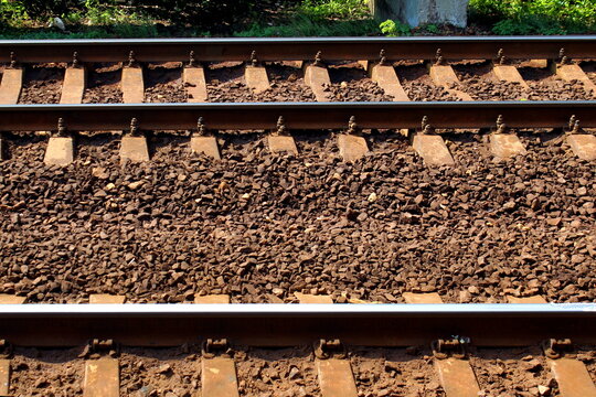 The rails and sleepers are lying on the ground.
