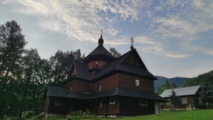 Fototapeta premium old wooden church in the middle of a green field