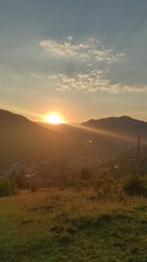 sunset in the mountains, beautiful view of mountains and houses at sunset