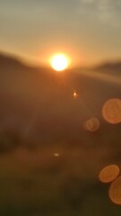 sunset in the mountains, bokeh from the sun