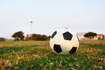 Nature, grass and ball for soccer on field for game, training or tournament league for sports. Outdoor, activity and equipment on lawn for football match, practice or competition on pitch at stadium.