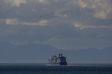 Luxury modern cruiseship cruise ship ocean liner Solstice in Alaska Inside Passage with Glacier mountains, archipelago and lush forest scenic landscape nature view
