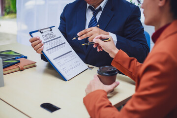 Real estate agent hands over keys to home to buyer after signing lease during home loan meeting. Property purchase agreement for new home ownership.