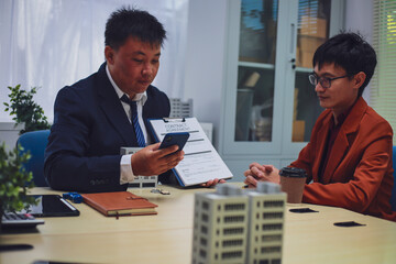 Real estate agent hands over keys to home to buyer after signing lease during home loan meeting. Property purchase agreement for new home ownership.