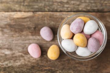 Easter chocolate egg on textured background. Easter celebration concept. Easter chocolate rabbit. Chocolate sweet eggs. Candies on textured wooden table. Space for text.Copy space. Gift. Banner.