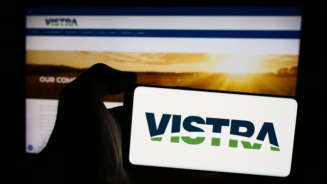 Stuttgart, Germany - 08-16-2024: Person holding mobile phone with logo of American energy company Vistra Corp. in front of business web page. Focus on phone display.