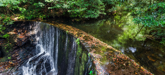 Water dam on a river where a waterfall is produced to feed the water mills for grinding grain, Taramundi, Asturias.