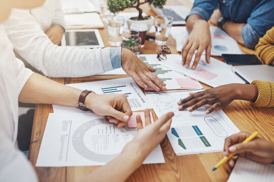 Team, hands and documents in office for meeting, budget planning and networking strategy. Business people, finance paper and tech at table for research analysis, projection or creative startup report