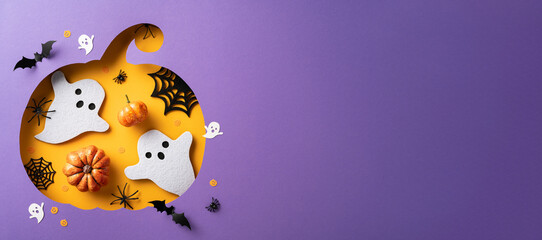 Stylish Halloween scene featuring paper ghosts, pumpkins, and bats on a purple background. Ideal...