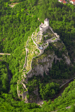 Aerial view of the ancient fortress in Uzice, Serbia, perched on a hilltop with scenic forest and mountain backdrop