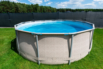 Large expansion pool with a diameter of 3.96 m, located in the yard on the grass.