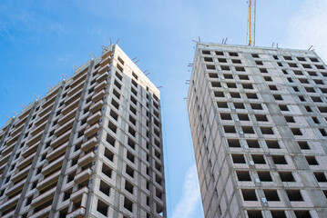 construction of new residential buildings. buildings under construction against the blue sky.