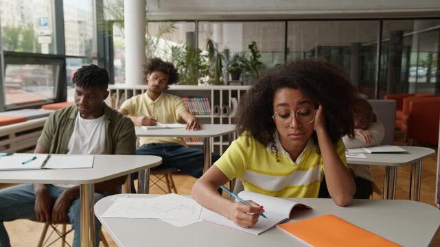 University high school students college lecture class lesson sad boring African American guys males men boys Caucasian girls women females ladies boredom suffer listening teacher study bored education