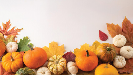Pumpkins and Gourds on Autumn Leaves with Copyspace