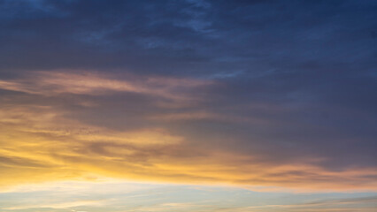 Glowing real sky at sunset texture background overlay. Dramatic red and orange clouds.