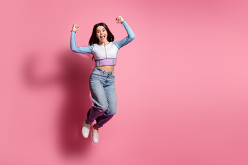 Photo of glad crazy cute girl wear blue trendy clothes hand fist yes empty space isolated on pink...