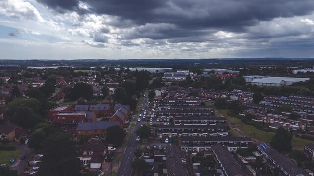 Aerial timelapse of real estate residential homes, with road and trees at Luton Town of UK at sunset
