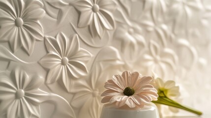 White embossed floral background with a soft pink flower on top of a white vase.