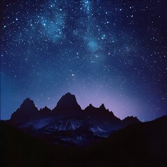 Breathtaking Starry Night Over Rugged Mountain Range Captured by Digital