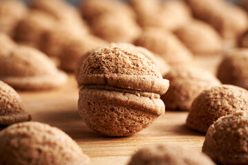 Baked homemade Christmas cookies in the form of nuts filled with cream, closeup